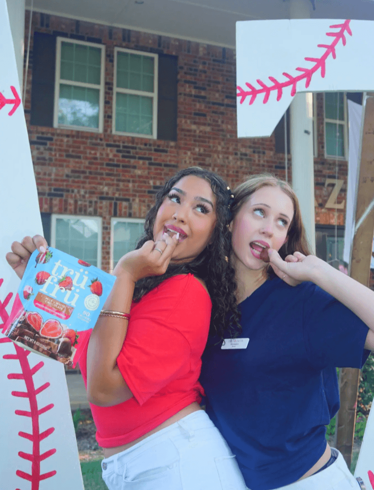 Two friends sharing Trü Frü at a game day tailgate